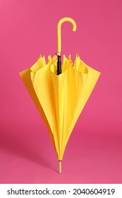 Stylish Closed Yellow Umbrella On Pink Background