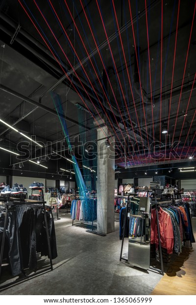 Stylish Clothing Store Dark Ceiling Hanging Stock Photo