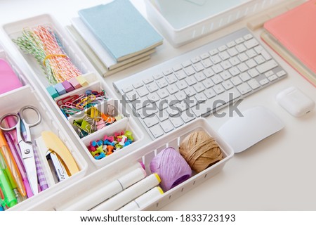 Stylish colored stationery in pastel colors. Female workplace. Organization of a drawer at the workplace. Storage and order of office supplies. Concept back to school.