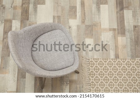 Stylish comfortable light grey chair on floor, top view. Space for text
