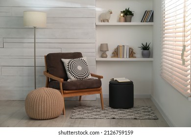 Stylish comfortable poufs near armchair in room. Home design