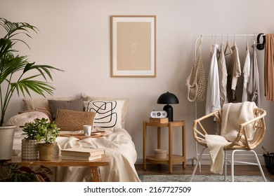 Stylish composition of cozy bedroom with mock up, beige bedding, and wooden armchair. Mock up poster with wooden frame. Home decor. Template.  - Shutterstock ID 2167727509