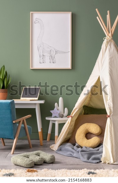 Stylish composition of cozy child room interior design\
with green wall with poster and armchair. Desk with computer and\
plant. Mock up poster. Pillow and bright carpet. Hut with pillows\
and plaid. \
