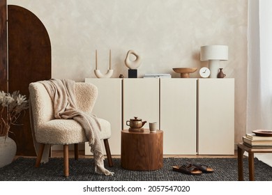 Stylish composition of cozy living room interior design with mock up poster frame, fluffy armchair, folding screen, coffee table, commode and personal accessories. Modern style. Template.