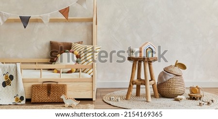 Stylish composition of cozy scandinavian child's room interior with wooden bed, toys and hanging decorations. Creative wall. Copy space. Template. 