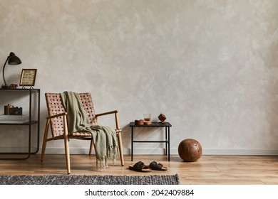 Stylish composition of elegant masculine living room interior with copy space, brown armchair, industrial shelfs and personal accessories. Template.   - Shutterstock ID 2042409884