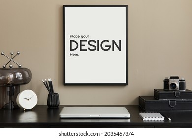 Stylish Composition Of Home Office Interior With Black Wooden Desk, Laptop, Mock Up Poster Frame, Design Table Lamp, Photo Camera, Organizer, Clock And Elegant Office Accessories. Template.