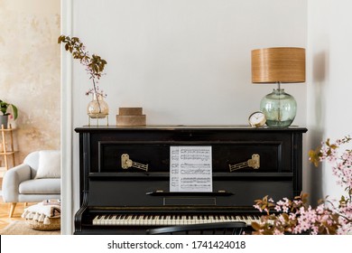 Stylish composition at living room interior with black piano, dried flowers in vase, gold clock, design lamp, boxes, copy space and elegant presonal accessories in modern home decor. - Powered by Shutterstock