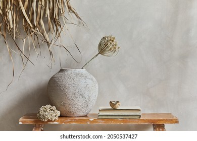 Stylish composition of living room interior with copy space, bench in retro style, clay vases and crockery. Rustic inspiration. Summer vibes. Beige wall. Template.