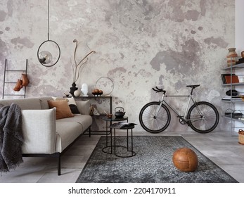 Stylish composition of living room interior with design gray sofa, bicycle, carpet, coffee table, decoration and elegant man accessories. Modern concrete wall. Minimalist home decor. Template.	 - Powered by Shutterstock