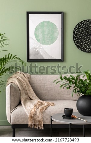 The stylish composition at living room interior with mock up, green wall, design gray sofa, coffee table and elegant personal accessories. Beige pillow and plaid. Mock up poster. Template. 