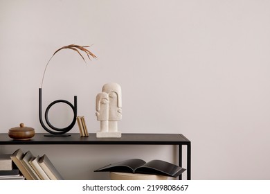 The stylish composition of minimalistic interior with copy space.  Black commode, vase with dried flowers, sculpture and personal accessories. Beige wall. Home decor. Template.  - Shutterstock ID 2199808667