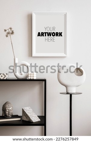 Stylish composition with mock up poster frame with black console, sculpture on the stand and personal accessories.