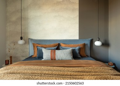 Stylish composition of modern bedroom interior. Bed, creative lamp and elegant personal accessories. Concrete wall. Brown sheeets. Minimalistic masculine concept. Template. - Shutterstock ID 2150602563