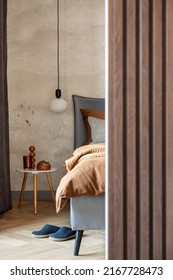 Stylish Composition Of Modern Bedroom Interior. Bed, Creative Lamp And Elegant Personal Accessories. Concrete Wall. Brown Sheeets. Minimalistic Masculine Concept. Template.