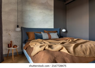Stylish composition of modern bedroom interior. Bed, creative lamp and elegant personal accessories. Concrete wall. Brown sheeets. Minimalistic masculine concept. Template. - Shutterstock ID 2167728475