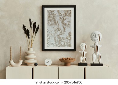 Stylish composition of modern beige living room interior design with designed sculptures, mock up poster frame, beige wooden sideboard and personal accessories. Template.