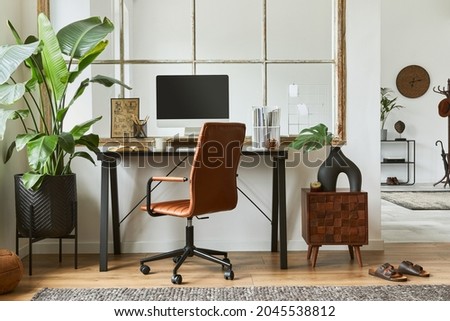 Stylish composition of modern masculine home office workspace interior design with black industrial desk, brown leather armchair, pc and stylish personal accessories. Template.