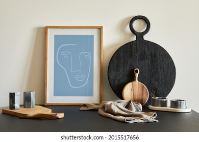 Stylish composition of modern small dining space interior. Black table, black and light wooden kitchen and dining accessories. Neutral walls. Minimalistic masculine concept. Details. Template. - Powered by Shutterstock