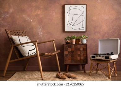 The stylish compostion at living room interior with mock up, design wooden sideboard and elegant personal accessories. Brown wall Cozy apartment. Home decor. Template. 