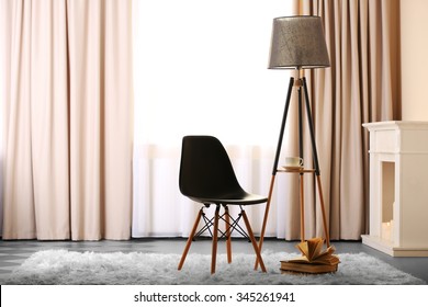 Stylish conception with chair and lamp on light room background
