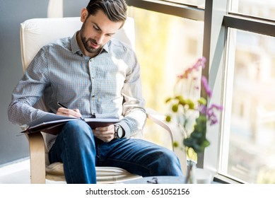 Stylish Confident Guy Writing In Journal