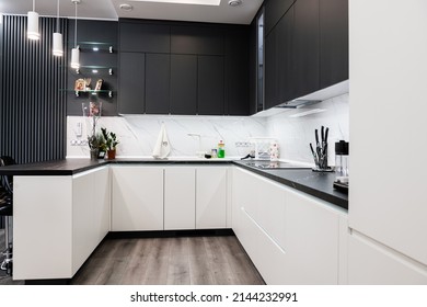 Stylish, corner kitchen with a table in black and white - Powered by Shutterstock