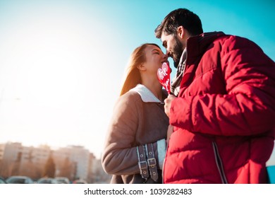 Stylish Couple Almost Kissing Outdoors.