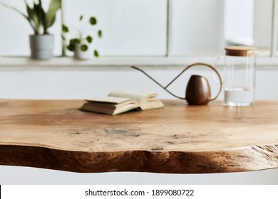 Stylish and cozy compositon of craft oak wooden table with chairs, watering can, glassy jug and modern floor in beautiful interior of design home. Template.