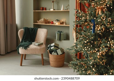 Stylish cozy home interior decorated for Christmas. Christmas tree and wrapped gifts in a modern living room.