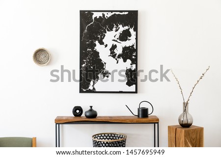 Stylish and cozy scandinavian interior of living room with wooden console, ring on the wall, cube, flowers and elegant personal accessories. Black mock up poster map. Design home decor. Template. 