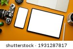 Stylish creative flat lay workspace with smartphone, tablet, camera, laptop and accessories, clipping path