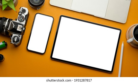 Stylish creative flat lay workspace with smartphone, tablet, camera, laptop and accessories, clipping path