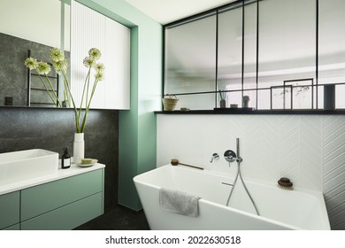 Stylish And Creative Minimalistic Small Bathroom Interior Design With Marble Walls With Green Panels, Plants And Beautiful Bathroom Accessories. Minimalistic Home Concept. Template.
