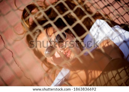 Similar – Young surfer woman with top and bikini kissing surfboard