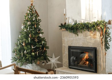 Stylish decorated christmas tree with vintage baubles  and modern decor on fireplace mantel with bells and ribbon. Modern christmas scandinavian living room. Atmospheric christmas eve - Powered by Shutterstock