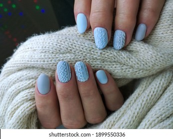 stylish design of manicure on nails in the style of minimalism. Blue-gray shade of gel polish for short nails. Winter design on a matte top on nails
.Knitting