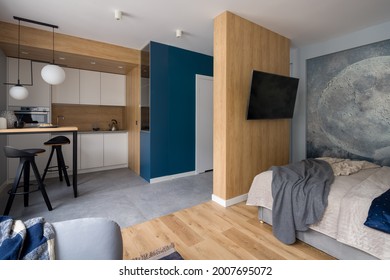Stylish designed studio apartment with kitchen open to living room and bedroom with tv - Shutterstock ID 2007695072