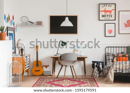 Stylish desk and chair in workspace in vintage genderless kid room