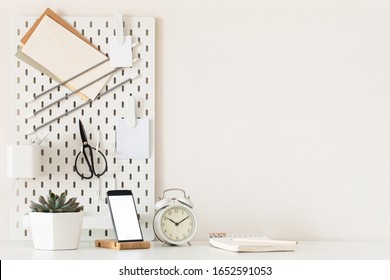 Stylish Desk Interior With White Table Background With Plant And Leaves. Modern Home Office Interior