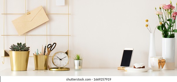 Stylish Desk Interior With White Table Background With Plant And Leaves. Modern Home Office Interior Panoramic Banner Backdrop