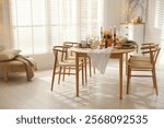 Stylish dining room with beautiful table setting and autumn decor