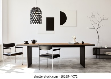 Stylish dining room interior with design wooden family table, black chairs, teapot with mug, mock up art paintings on the wall and elegant accessories in modern home decor. Template. - Shutterstock ID 1816544072