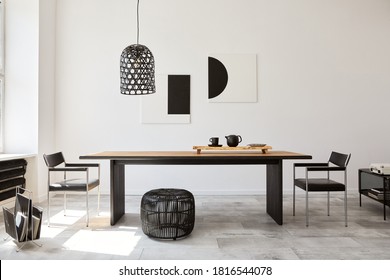 Stylish dining room interior with design wooden family table, black chairs, teapot with mug, mock up art paintings on the wall and elegant accessories in modern home decor. Template. - Shutterstock ID 1816544078