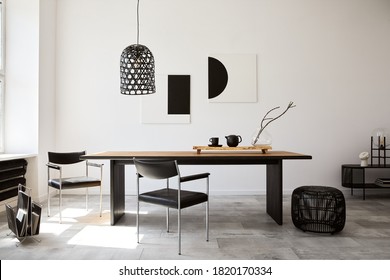 Stylish dining room interior with design wooden family table, black chairs, teapot with mug, mock up art paintings on the wall and elegant accessories in modern home decor. Template. - Shutterstock ID 1820170334