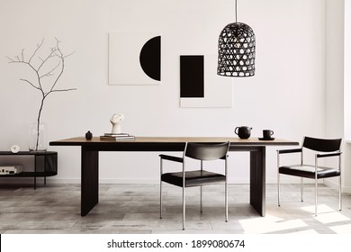 Stylish dining room interior with design wooden family table, black chairs, teapot with mug, mock up art paintings on the wall and elegant accessories in modern home decor. Template. - Shutterstock ID 1899080674