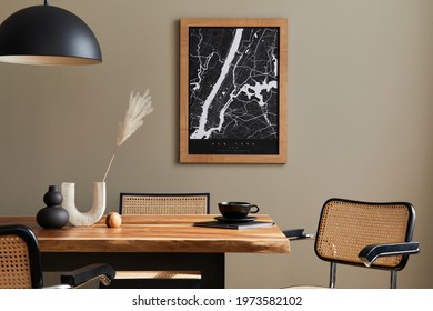 Stylish dining room interior with mock up poster map, wooden walnut table, design chairs, cup of coffee, decoration, tableware and elegant personal accessories in home decor. Template.