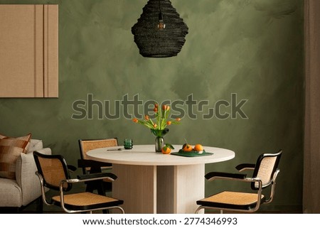 A stylish dining space showcases a unique green textured wall, round wooden table, and mid-century modern rattan chairs, creating a calm and inviting atmosphere for home decor and interior design