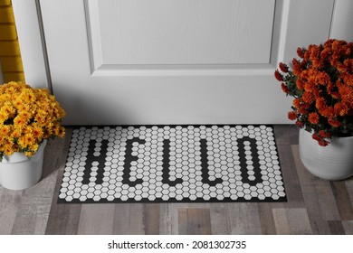 Stylish Door Mat With Word Hello And Beautiful Flowers On Wooden Floor