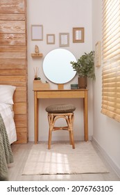 Stylish Dressing Table And Mirror Near White Wall In Bedroom. Interior Design